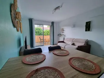 a living room with a table with three plates on it at Appartement entier cosy au calme in Le Cannet