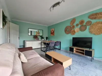a living room with a couch and a table at Appartement entier cosy au calme in Le Cannet