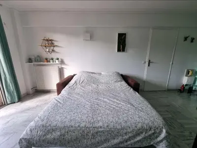 a bedroom with a bed with a blanket on it at Appartement entier cosy au calme in Le Cannet