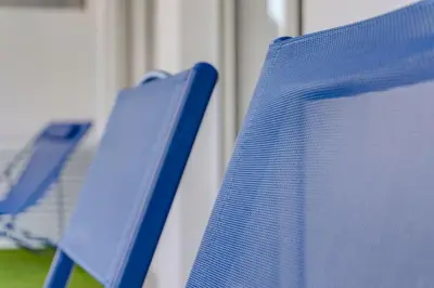 two blue chairs sitting next to each other at 2 chambres - Grand balcon - à 1 min de la plage in Cannes