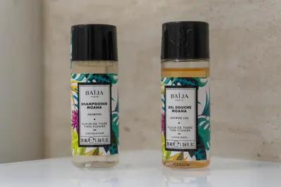 two bottles of hair products sitting on a table at 2 chambres - Grand balcon - à 1 min de la plage in Cannes
