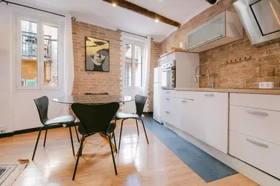 a kitchen with a table and chairs in a room at La Casa du Suquet, zone piétonne in Cannes