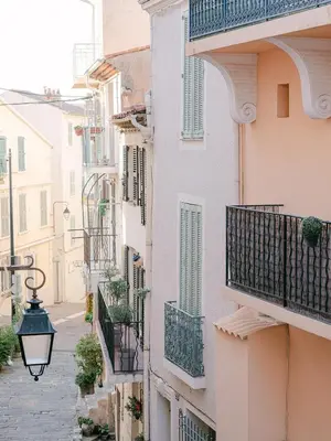 an alley in an old town with balconies at La Casa du Suquet, zone piétonne in Cannes