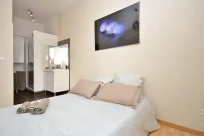 a bedroom with a white bed with a tv on the wall at La Terrasse 4 Cannes French Riviera in Cannes