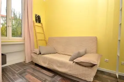 a yellow room with a couch with a laptop on it at La Terrasse 4 Cannes French Riviera in Cannes