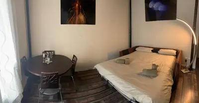 a small bedroom with a bed and a table at La Terrasse 4 Cannes French Riviera in Cannes