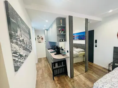a bathroom with a sink and a mirror in a room at Le Pinson Mignon Cannes Carre d Or in Cannes