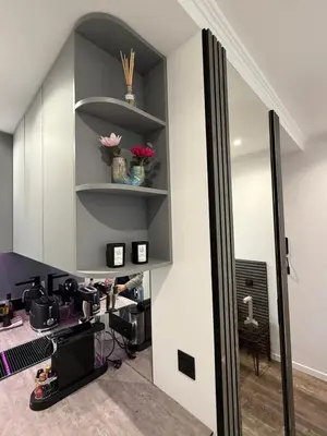 a room with a mirror and a desk with flowers at Le Pinson Mignon Cannes Carre d Or in Cannes