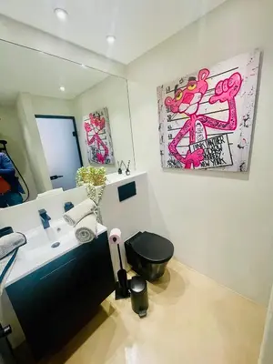 a bathroom with a sink and a toilet and a mirror at Le Pinson Mignon Cannes Carre d Or in Cannes