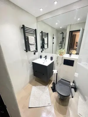 a bathroom with a black toilet and a sink at Le Pinson Mignon Cannes Carre d Or in Cannes