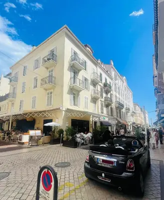 a black car parked in front of a building at Le Pinson Mignon Cannes Carre d Or in Cannes