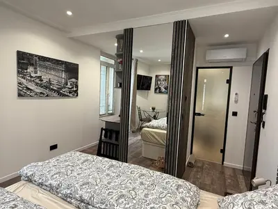 a bedroom with two beds and a mirror at Le Pinson Mignon Cannes Carre d Or in Cannes