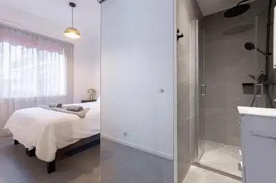 a bedroom with a bed and a glass shower at YELLOW DUBOY D'ANGERS 2 Bedrooms in Cannes