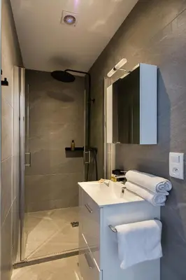 a bathroom with a sink and a shower at YELLOW DUBOY D'ANGERS 2 Bedrooms in Cannes