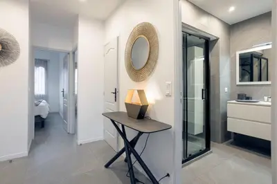 a bathroom with a table and a mirror and a sink at YELLOW DUBOY D'ANGERS 2 Bedrooms in Cannes