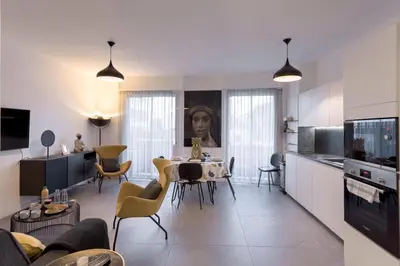 a kitchen and living room with a table and chairs at YELLOW DUBOY D'ANGERS 2 Bedrooms in Cannes