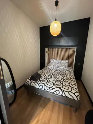 a bathroom with a shower with a wooden door at T2 avec terrasse 4p, Cannes centre in Cannes