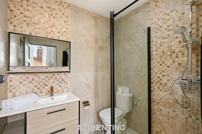 a kitchen with blue cabinets and a white refrigerator at Azurenting - Bastide Mira - 1 chambre - Balcon in Cannes