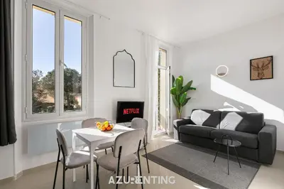 a bedroom with a bed and a red curtain at Azurenting - Bastide Mira - 1 chambre - Balcon in Cannes