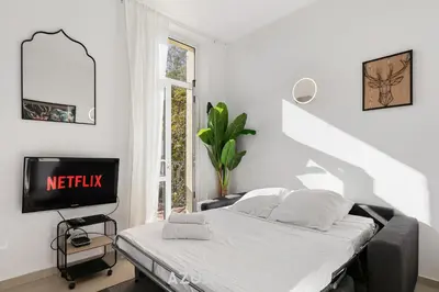 a house with a large yard in front of a building at Azurenting - Bastide Mira - 1 chambre - Balcon in Cannes