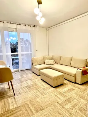 a living room with a couch and a table at Charming Flat close to beach in Cannes
