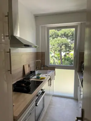 a kitchen with a sink and a window at Charming Flat close to beach in Cannes