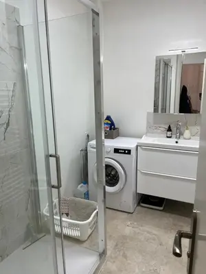 a bathroom with a washing machine and a sink at Charming Flat close to beach in Cannes