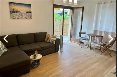a living room with a couch and a table and chairs at CANNES Inn Appartement in Le Cannet