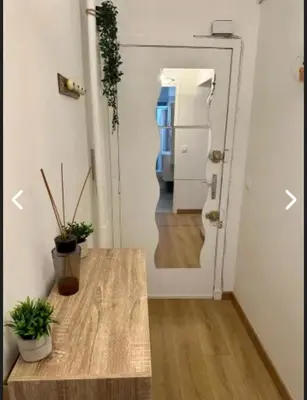 a room with a table and a door with a hallway at CANNES Inn Appartement in Le Cannet