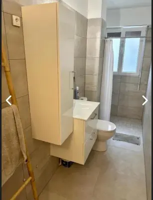a bathroom with a white sink and a toilet at CANNES Inn Appartement in Le Cannet