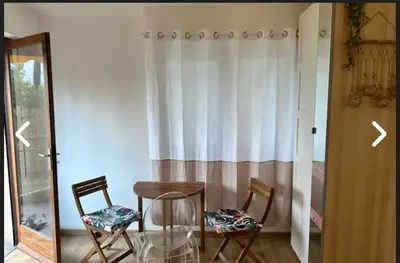 a room with two chairs and a table and a mirror at CANNES Inn Appartement in Le Cannet