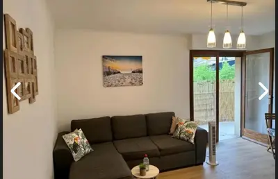 a living room with a couch and a table at CANNES Inn Appartement in Le Cannet