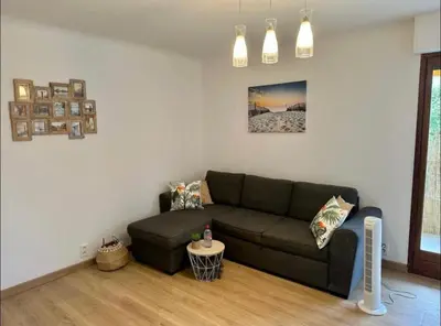 a living room with a couch and a table at CANNES Inn Appartement in Le Cannet