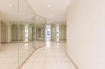 a hallway with glass columns in a building at LB Vacation Rentals I Beautiful 2BR Apt, Renovated in 2025, La Croisette, Minutes from Beach and Palais in Cannes