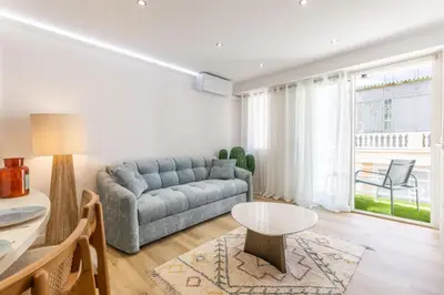 a living room with a couch and a table at LB Vacation Rentals I Beautiful 2BR Apt, Renovated in 2025, La Croisette, Minutes from Beach and Palais in Cannes
