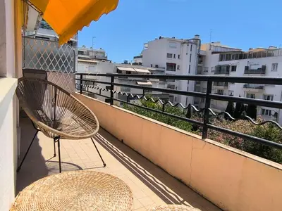 a chair sitting on the balcony of a building at Studio au calme 100 mètres de la croisette in Cannes