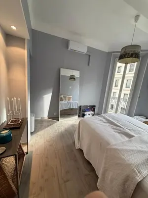 a bedroom with a large bed and a mirror at Foch 1 - Luminous apartment in city center w balcony in Cannes