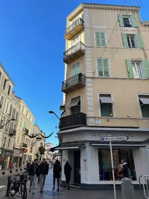 a group of people walking down a street in front of a building at Foch 1 - Luminous apartment in city center w balcony in Cannes