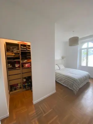 a bedroom with a bed and an open closet at Lisa Appartement de charme in Cannes