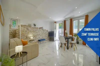 a living room with a couch and a table at Le Jo - Centre - Terrasse - Verrière Côte d'Azur in Cannes