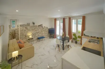 a living room with a couch and a table at Le Jo - Centre - Terrasse - Verrière Côte d'Azur in Cannes