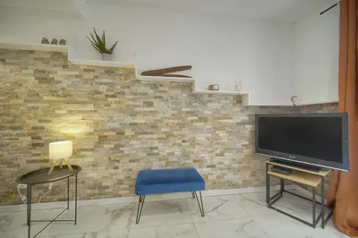 a living room with a television and two chairs at Le Jo - Centre - Terrasse - Verrière Côte d'Azur in Cannes