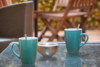 two green cups sitting on a table with a bowl at Le Jo - Centre - Terrasse - Verrière Côte d'Azur in Cannes