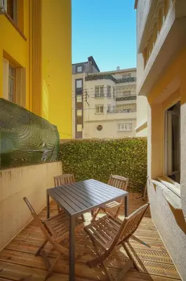 a table and chairs on a balcony with a building at Le Jo - Centre - Terrasse - Verrière Côte d'Azur in Cannes