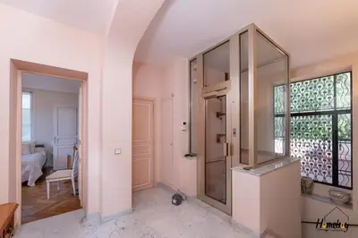 a room with a glass door and a window at La Gloriette Azur piscine sauna vue mer in Cannes