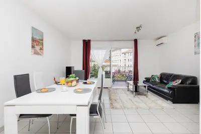 a living room with a white table and a couch at Cannes Maria YourHostHelper in Cannes