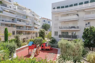 a red truck parked in front of a building at Cannes Maria YourHostHelper in Cannes