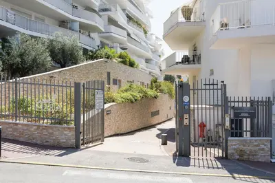 a gate in front of a building with a fire hydrant at Cannes Maria YourHostHelper in Cannes