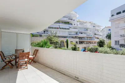 a balcony with a table and chairs and a building at Cannes Maria YourHostHelper in Cannes