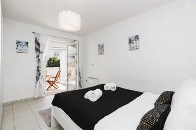 a bedroom with a bed with two towels on it at Cannes Maria YourHostHelper in Cannes